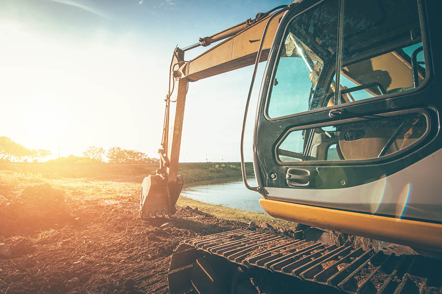 Excavation Contractor Insurance - Truck Digging into the Earth for a Building Project